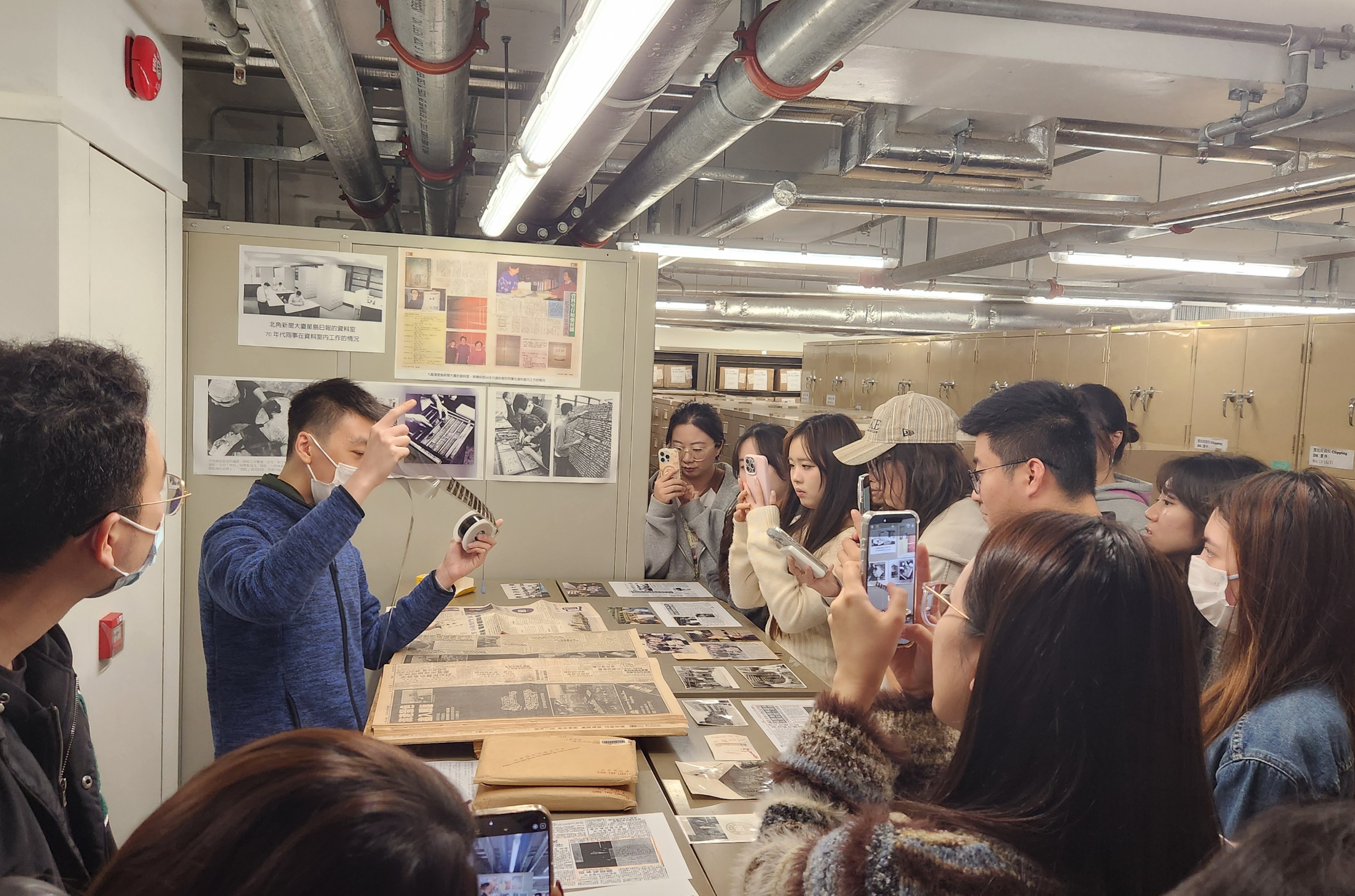 MScMCE students explored historical newspaper clippings and photographs related to HKBU at Sing Tao News Corporation Limited.