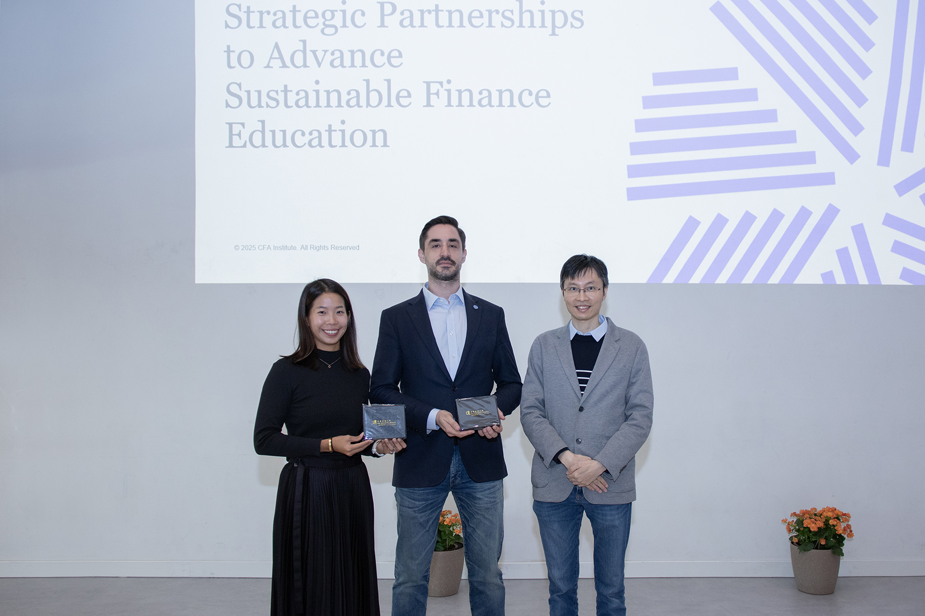 Dr Chan Kar-lun (1st right), Programme Director of MSc in Applied Economics, presents souvenir as the representative of the participating master’s programmes to the delegates from CFA Institute (1st left and middle) at the info session.