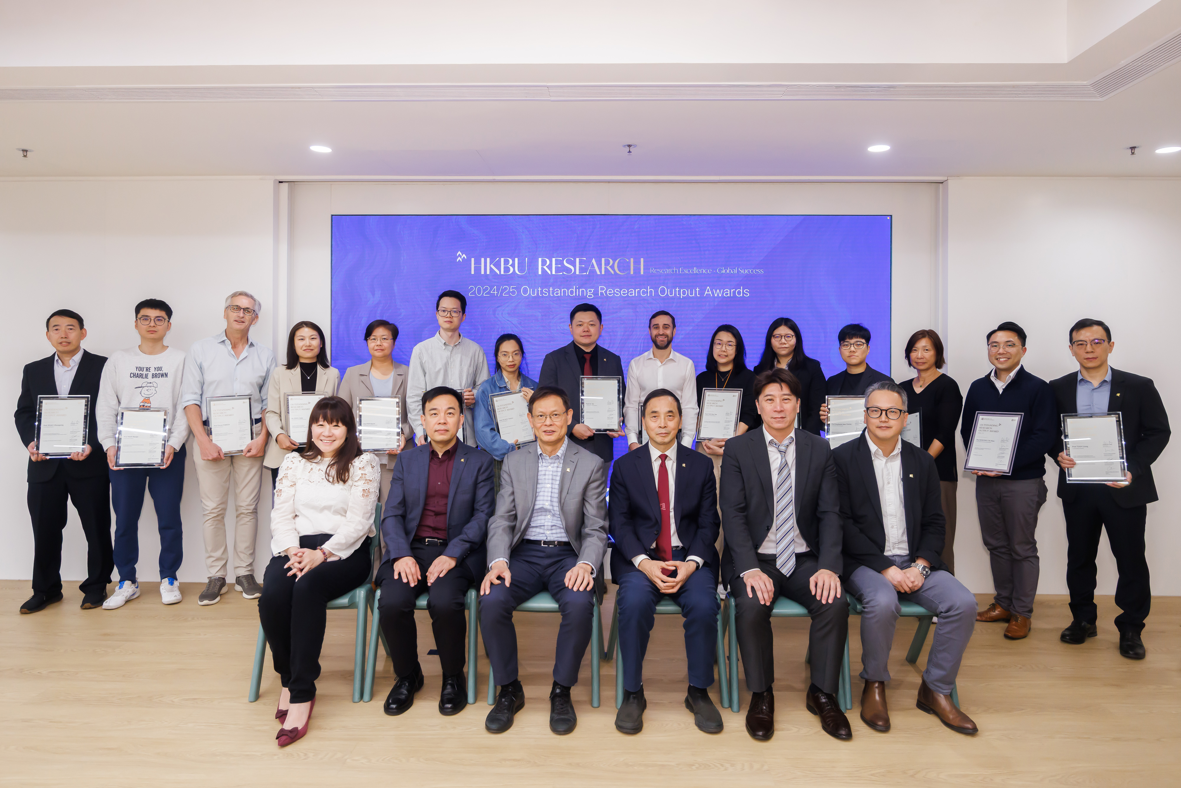 The three awardees from the School among 17 esteemed winners across different schools gathered for a group photo with the University representatives.
