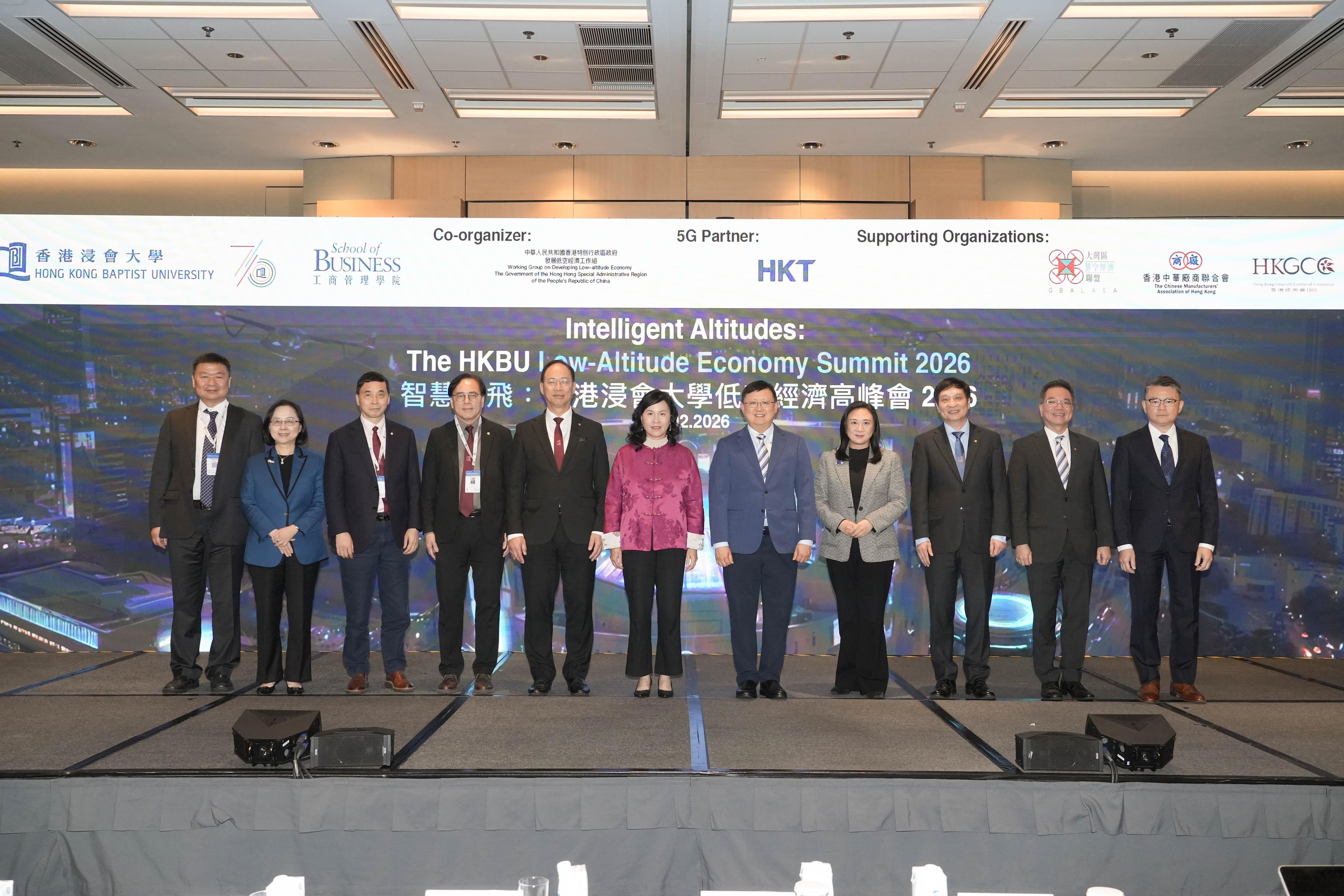 The Summit is officiated by Ms Mable Chan, JP, Secretary for Transport and Logistics, Government of the HKSAR (centre); The Hon Elizabeth Quat, BBS, JP, Member of the Legislative Council of the HKSAR and Founding President of the Greater Bay Area Low Altitude Economy Alliance (4th right); Ms Agnes Chan, Chairman of the Hong Kong General Chamber of Commerce (2nd left); Mr Bond Law, Executive Director of the Hong Kong Retail Management Association (1st right); Dr Kennedy Y H Wong, Chairman of the Council and the Court of HKBU (5th right); Professor Alex Wai, President and Vice-Chancellor of HKBU (5th left); Professor Martin Wong, Provost of HKBU (4th left); Professor Lyu Aiping, Vice-President (Research and Development) cum Dean of Graduate School of HKBU (3rd left); Professor Terence Lau, Interim Chief Innovation Officer of HKBU (2nd right); Professor Zhang Han, Dean and Chair Professor of the School of Business at HKBU (3rd right); and Professor Shan Xiaowen, Chair Professor, Institute for Advanced Study at Beijing Normal-Hong Kong Baptist University (1st left).