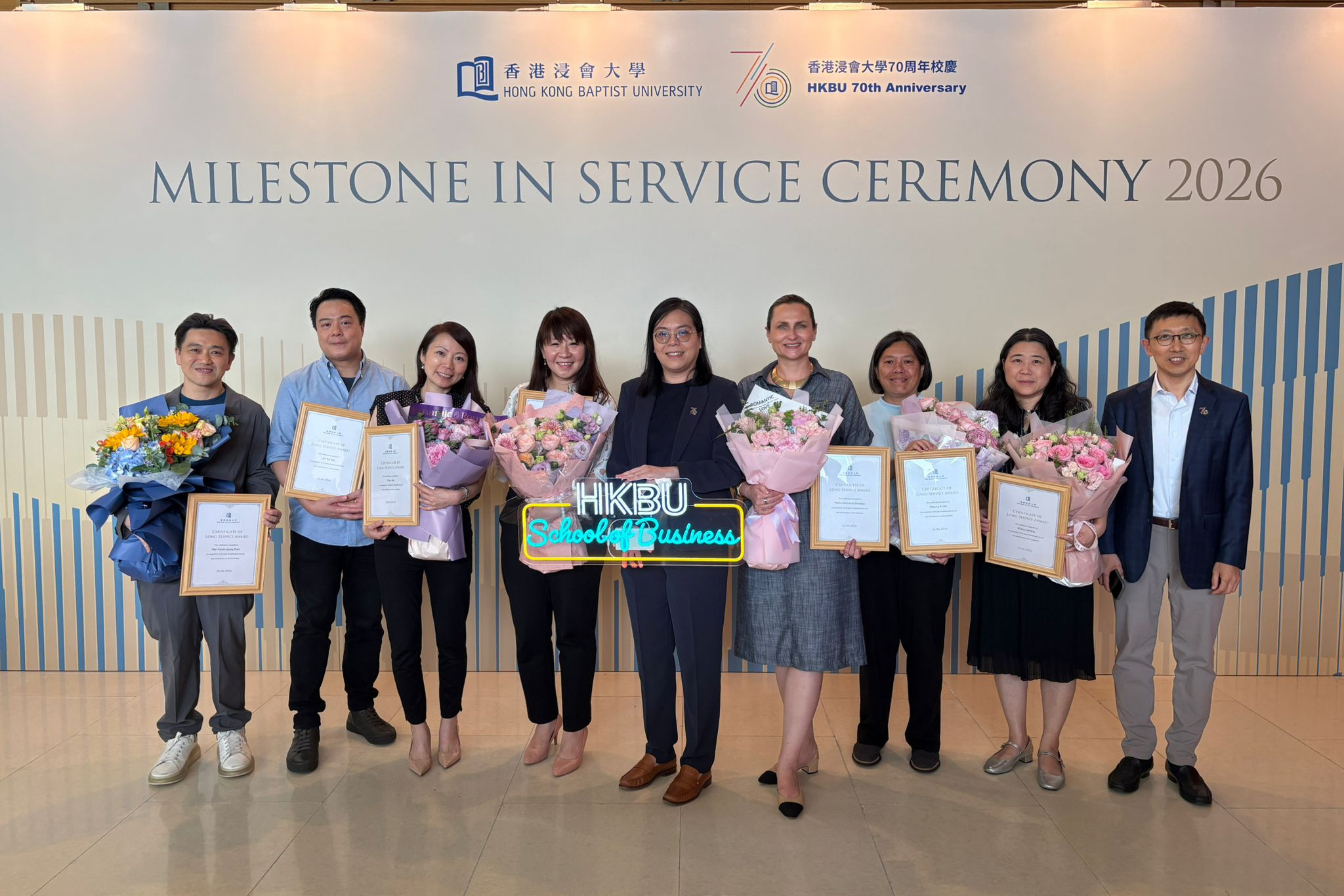 Group photo featuring (from left to right): Mr Ryan Man, Senior Lecturer, Department of Accountancy, Economics and Finance (AEF); Mr Franky Lam, Senior Information Technology Officer, School of Business;  Professor Kimmy Chan, Professor, Department of Management, Marketing and Information Systems (MMIS);  Professor Christy Cheung, Chair Professor, Department of Management, Marketing and Information Systems (MMIS); Professor Monique Wan, Associate Dean (Taught Postgraduate Studies), HKBU School of Business;  Dr Marta Dowejko, Senior Lecturer, Department of Management, Marketing and Information Systems (MMIS); Dr Jamie Cheung, Senior Lecturer, Department of Management, Marketing and Information Systems (MMIS); Professor Tracy Zhang, Associate Professor, Department of Management, Marketing and Information Systems (MMIS); Professor Byron Song, Head, Department of Accountancy, Economics and Finance (AEF), HKBU School of Business, to celebrate the Milestone in Service Ceremony 2026.